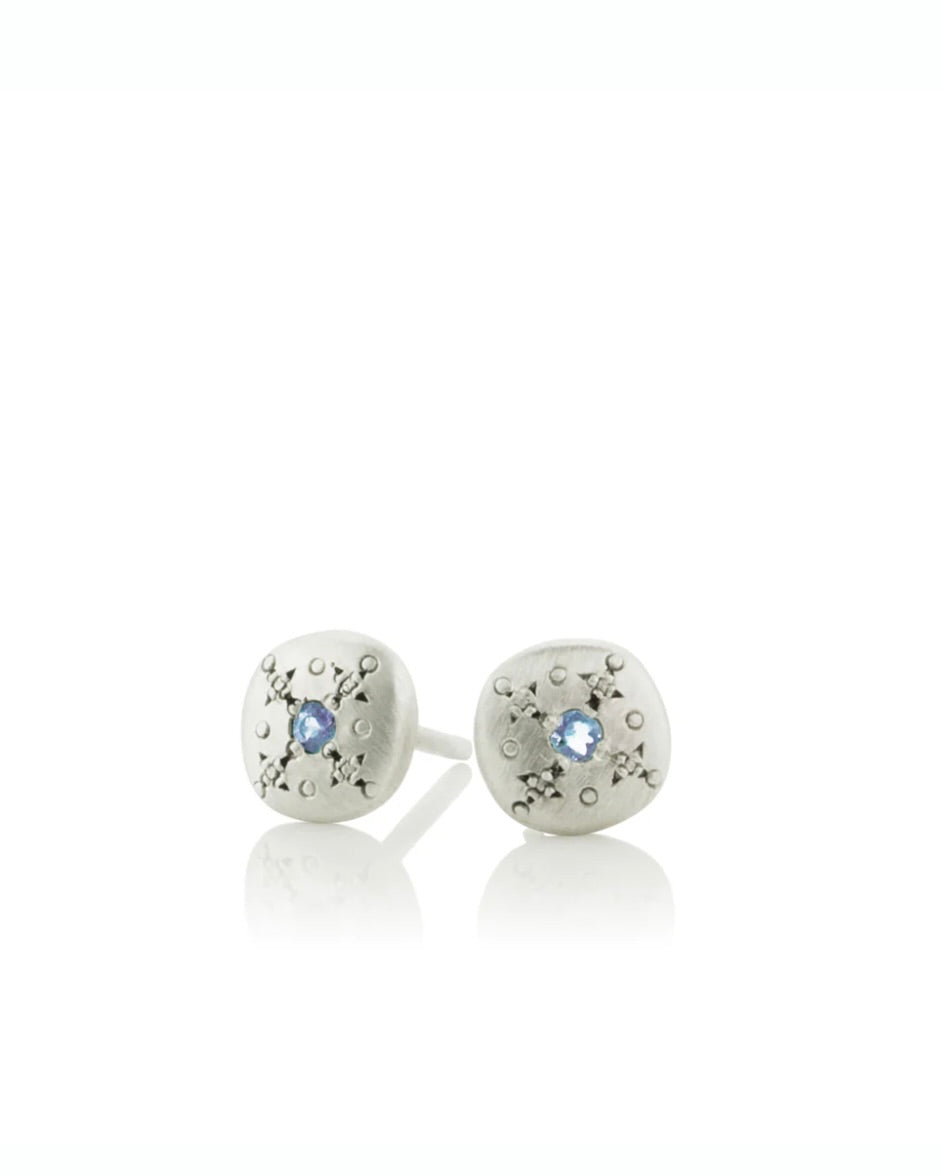 Tiny silver stud earrings with aquamarine.