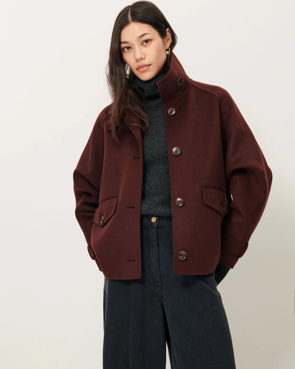 Woman wearing a brown coat on a white background