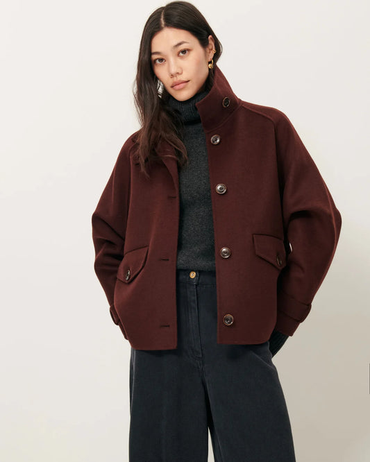 Woman wearing a brown coat on a white background