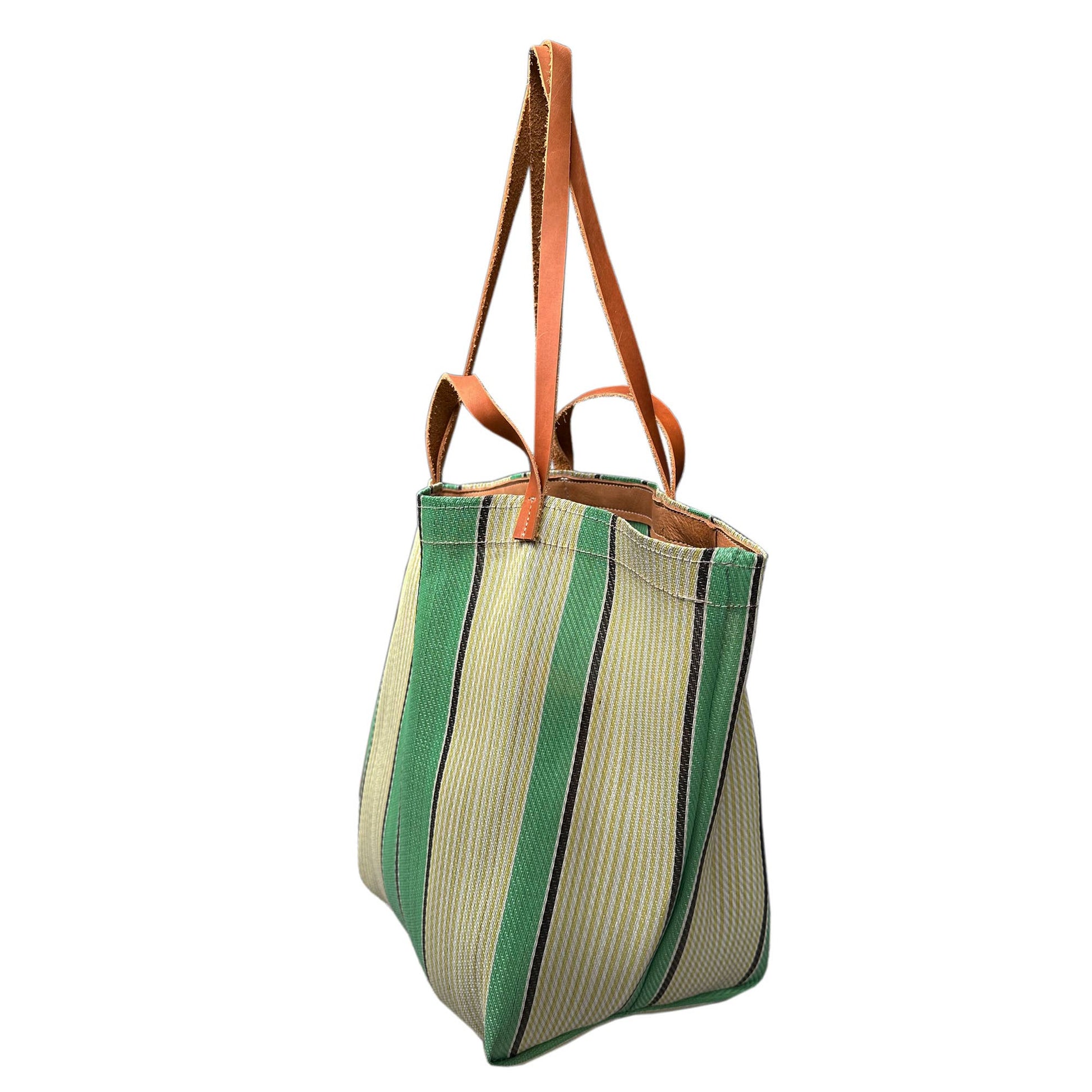 Picture ofgreen and white striped tote bag on a white background. View from side.