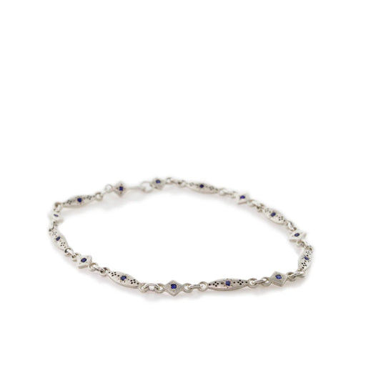 Silver bracelet with small stones on a white background