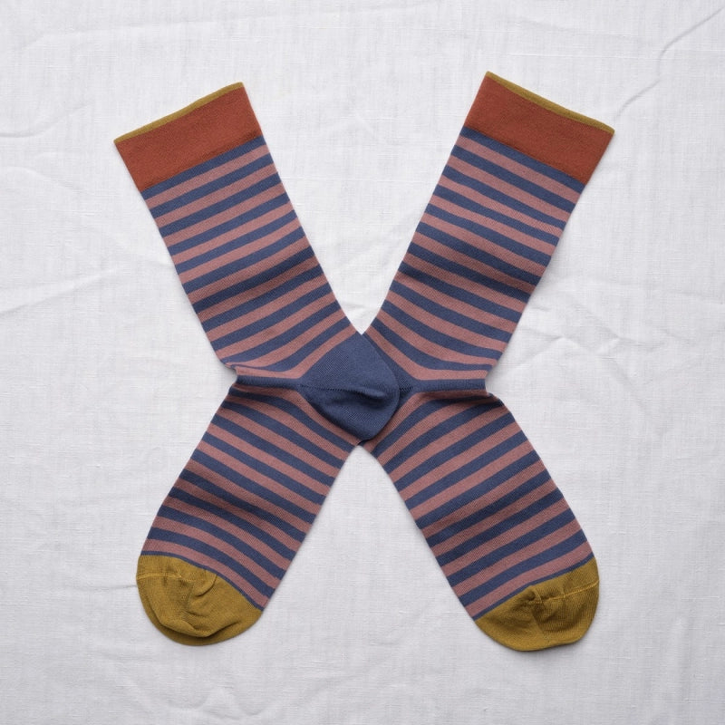 Pair of striped socks with brown, blue, and gold colors on a white background