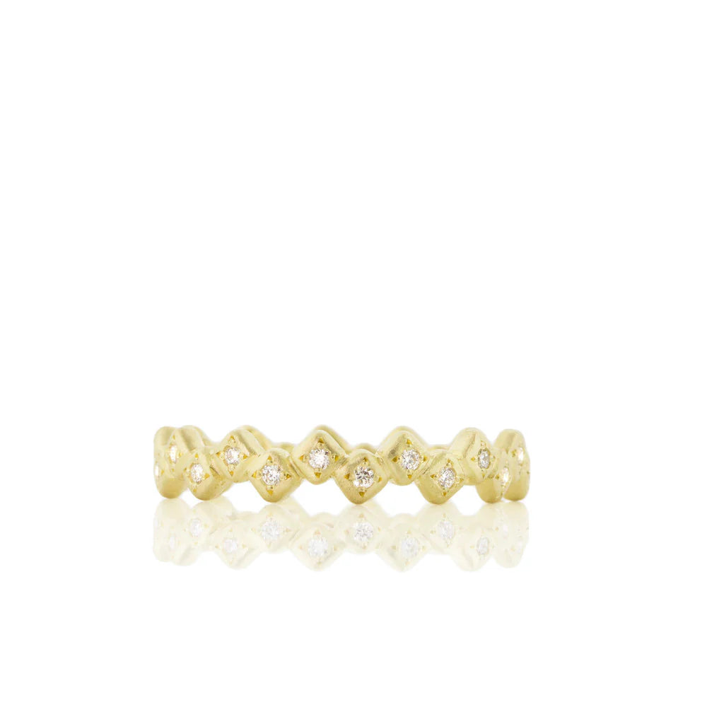 Gold ring with diamond accents on a white background