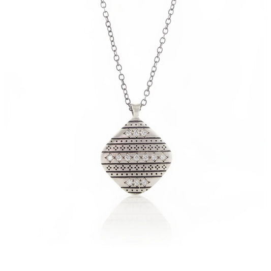 Silver necklace with a round, patterned pendant on a white background