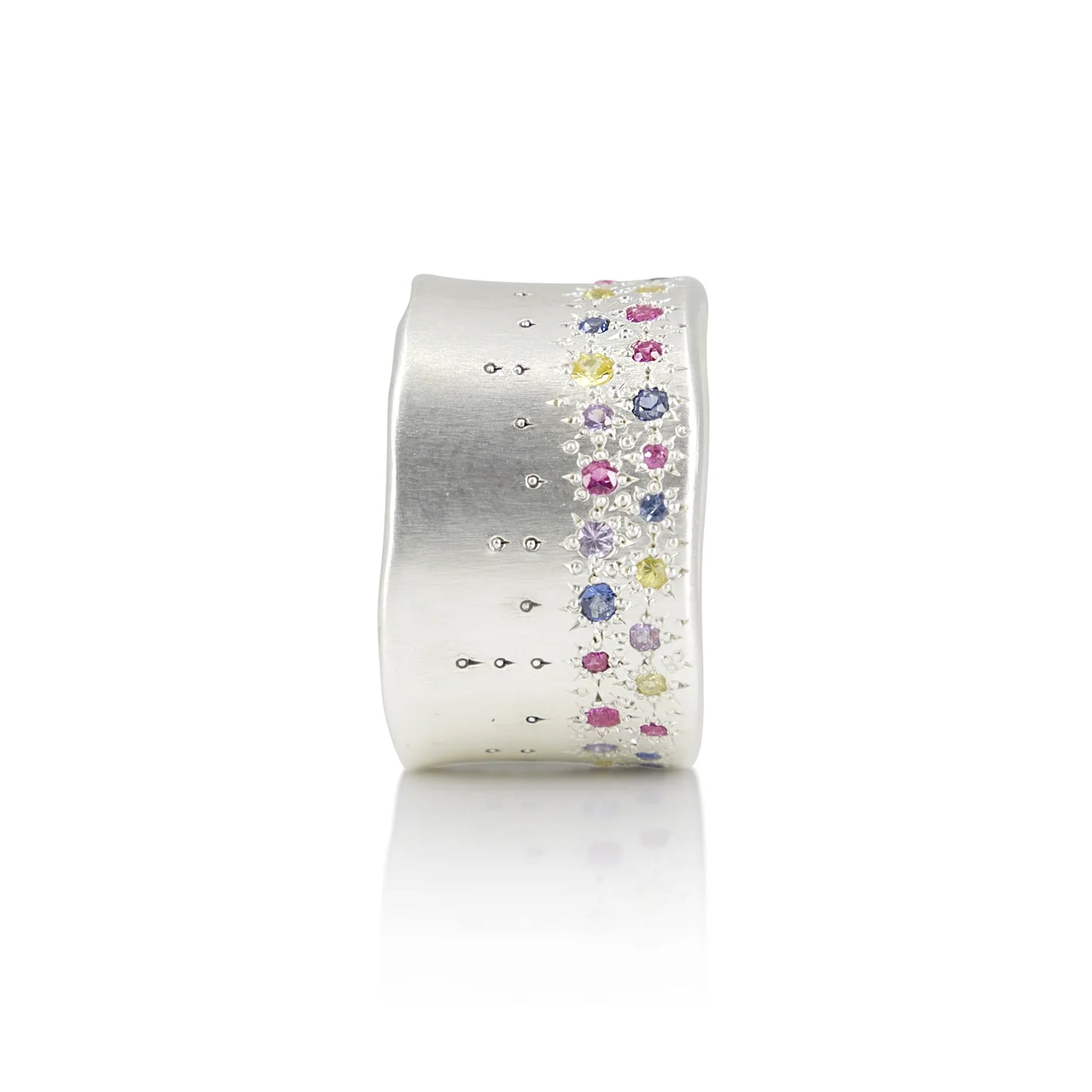Silver ring with colorful gemstones on a white background