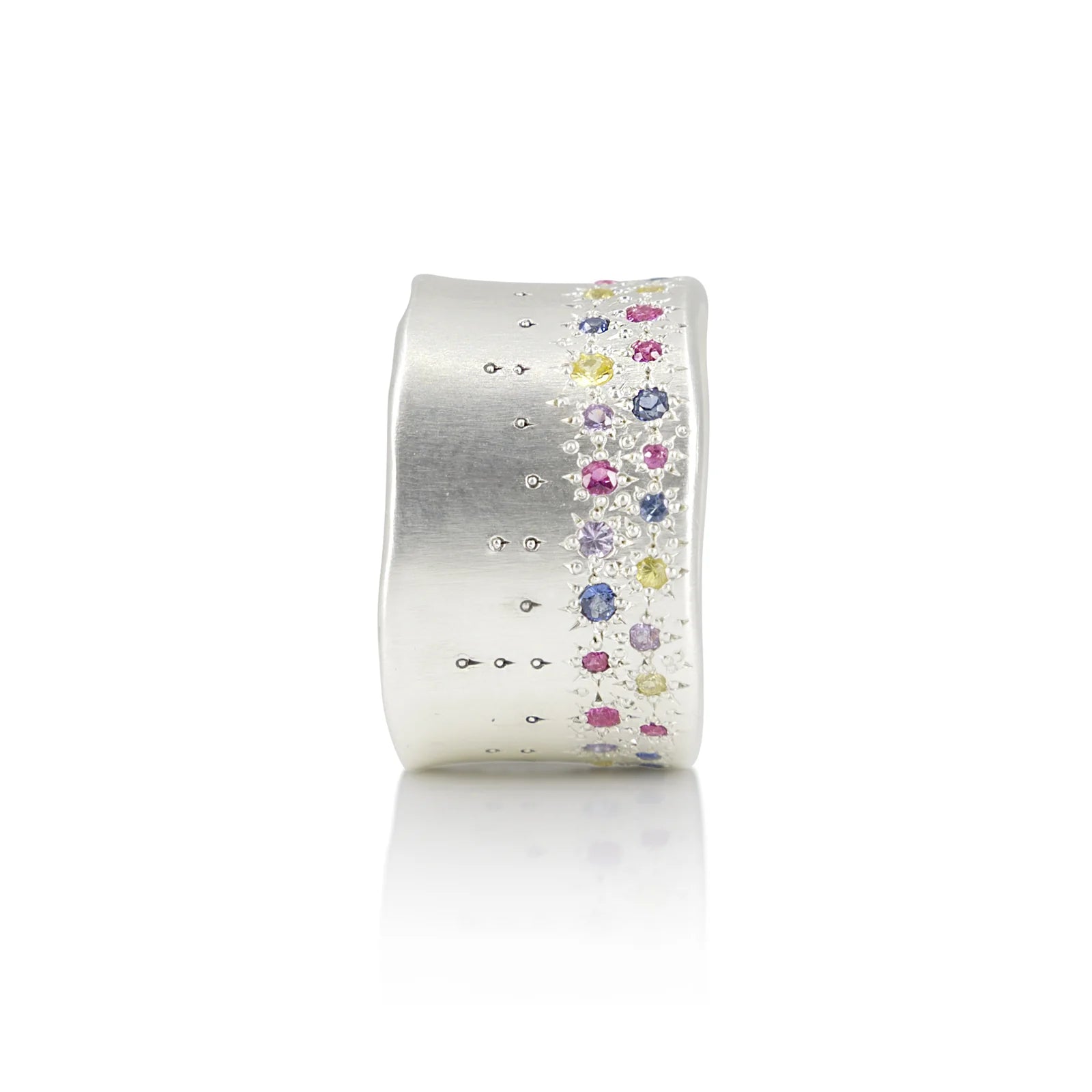 Silver ring with colorful gemstones on a white background